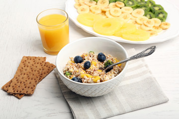 Tasty oatmeal and fruits on wooden background. Healthy eating concept.