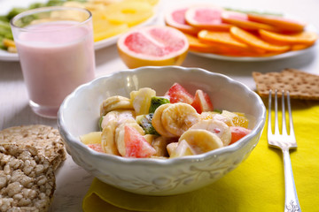 Fruit salad on wooden background. Healthy eating concept.
