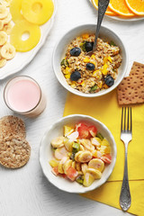 Tasty oatmeal and fruit salad on wooden background. Healthy eating concept.