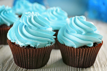 Blue cupcakes on wooden table