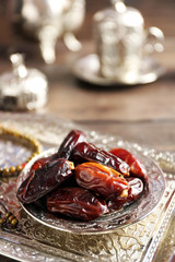 Dates fruit and rosary on beautiful tray, close up