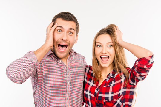  Funny cheerful couple showing surprise