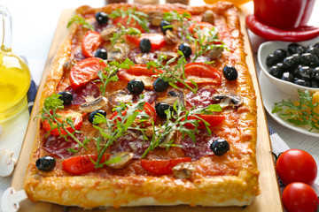 Rectangle delicious pizza and vegetables on the table