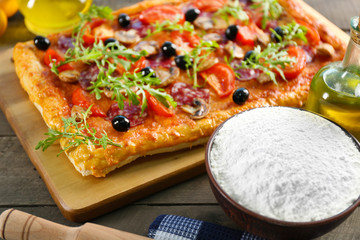 Rectangle delicious pizza and vegetables on the table