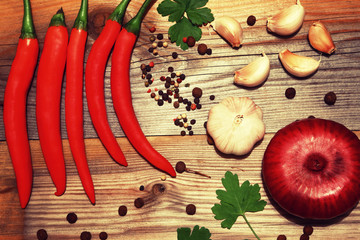 Spices. Pepper, garlic, onions, parsley. Tree background. Rural still life