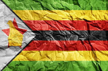 Zimbabwe flag painted on crumpled paper background