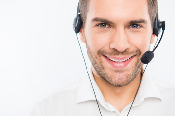 A close-up photo of smiling young agent of call centre