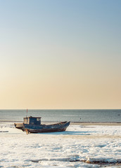Obraz premium old fishing boat at sunset time -yantai,china