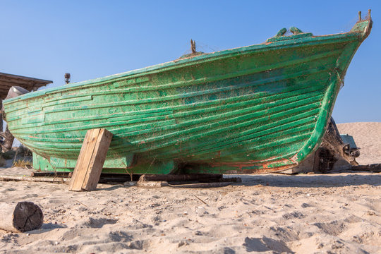 old boat on the sandy shore