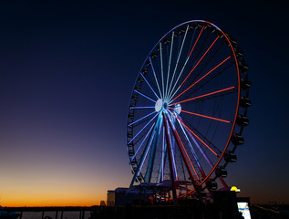 ferris wheel lit up red, white and blue