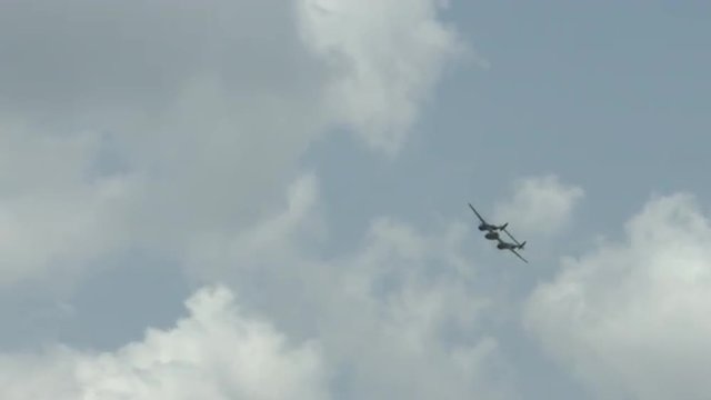 Lockheed P-38 Lightning flying in summer sky.  Fighter plane used by US Air Force in World War II.  Recorded in 4K, ultra high definition.