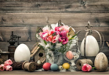 Easter decoration with pink tulips and colored eggs