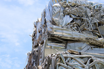 Stacked cubes of crushed compacted scrap metal at a county recycling center