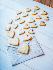 love flies out of the envelope. romantic message on Valentine's Day. cookies in the shape of heart