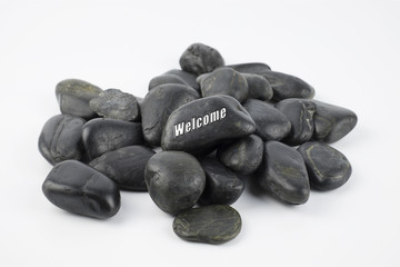Black pebble with Welcome word on white background