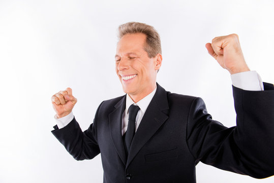 Successful happy businessman with fists raised