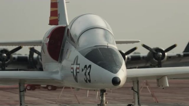 Pan across wing to the cockpit of an L-39 Albatross jet trainer, parked in early morning.  Recorded in 4K, ultra high definition.