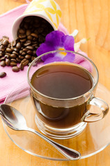 The cup of hot coffee on wooden background in the morning