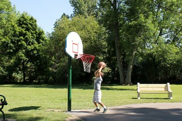 Young Boy Playing Basketball; Getting Ready to Shoot the Ball
