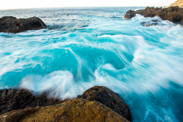 Seascape view on rocky coast with waves