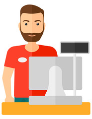 Salesman standing  at checkout.