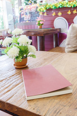 Red notebooks on wooden table