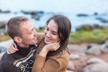 Loving couple hugging on the rocky beach