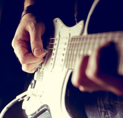 Young man playing electric guitar. Music, instrument education, entertainment, rock star, music concert and learning concept