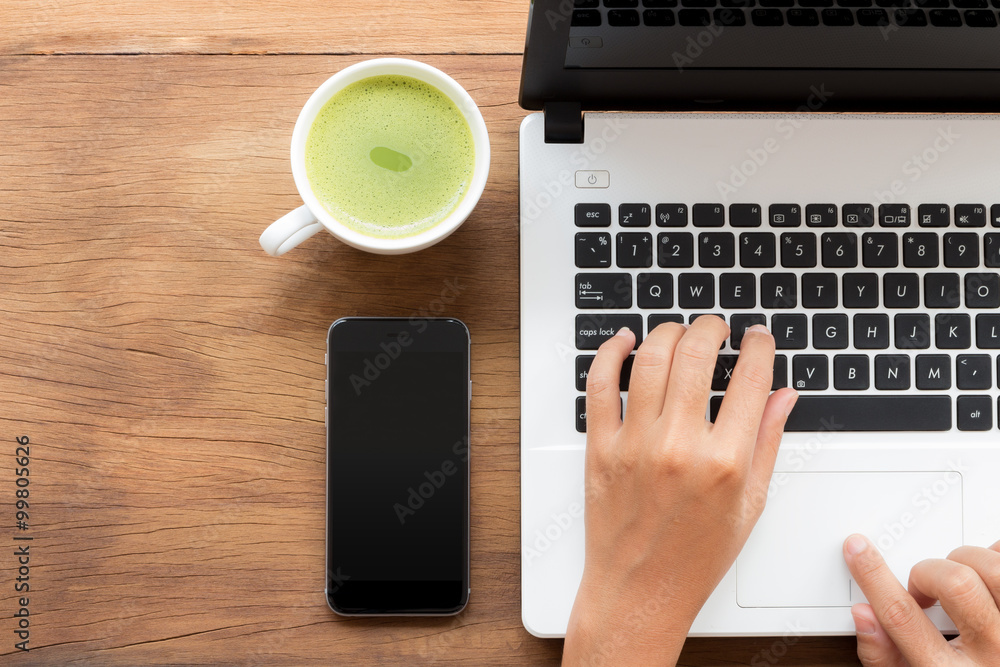 Aufkleber using laptop computer on workspace