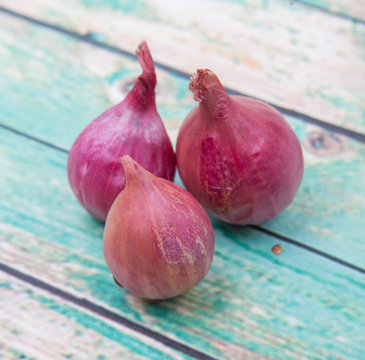 Shallots over wooden background