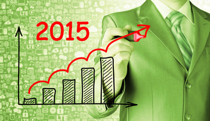 business man drawing growth graph for year 2015