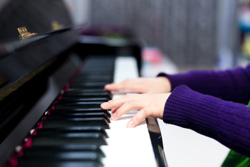 Obraz premium Asian cute boy playing piano at home