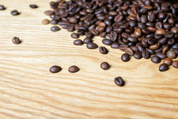 Fresh coffee beans on a wooden background for the preparation of