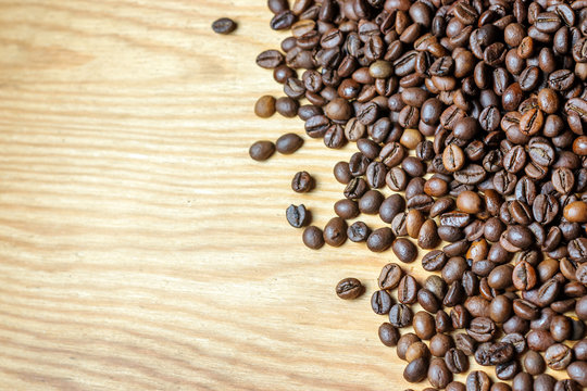 Fresh coffee beans on a wooden background for the preparation of © yvsedova