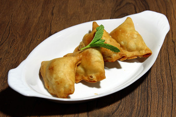 Samosa, and Inidan snack with a spicy potato stuffing.