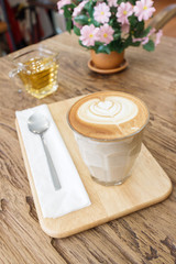 Cup of coffee latte art on wood table