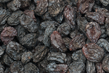 Black dried grapes on a white background