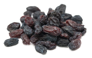 Black dried grapes on a white background