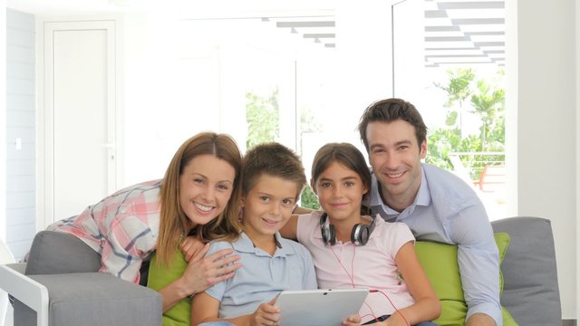 Parents watching kids websurfing with digital tablet