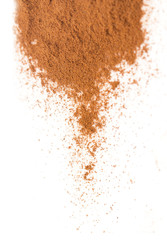ground cinnamon on a white background