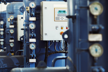 Closeup image of barometers at a brewery industrial plant.