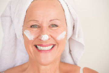 Joyful Mature Woman face moisturizer