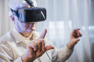 Close-up old man  getting experience using VR-headset glasses of virtual reality  at home