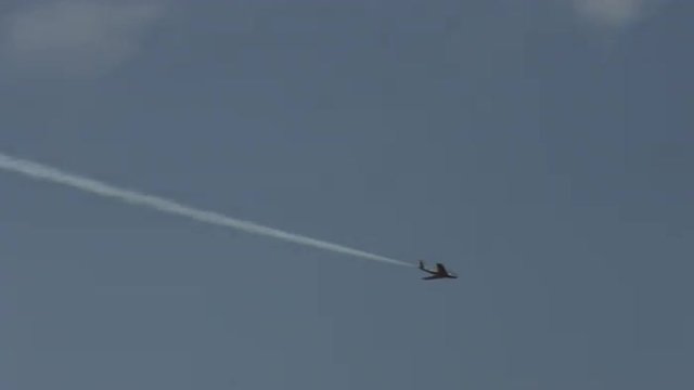 North American F-86 Sabre jet fighter leaves contrails while executing fast maneuvers .  Recorded in 4K, ultra high definition.