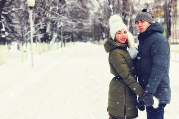 couple of young lovers walk in winter