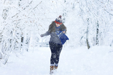 Fototapeta na wymiar girl in a scarf winter snow park