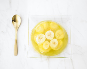 gelatin dessert with banana on white marble