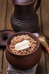 Freshly cooked buckwheat porridge in a clay pot