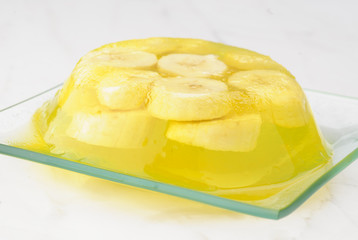 gelatin dessert with banana on white marble