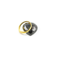 Closeup beautiful golden ring with black jasper in heart shape isolated on white background